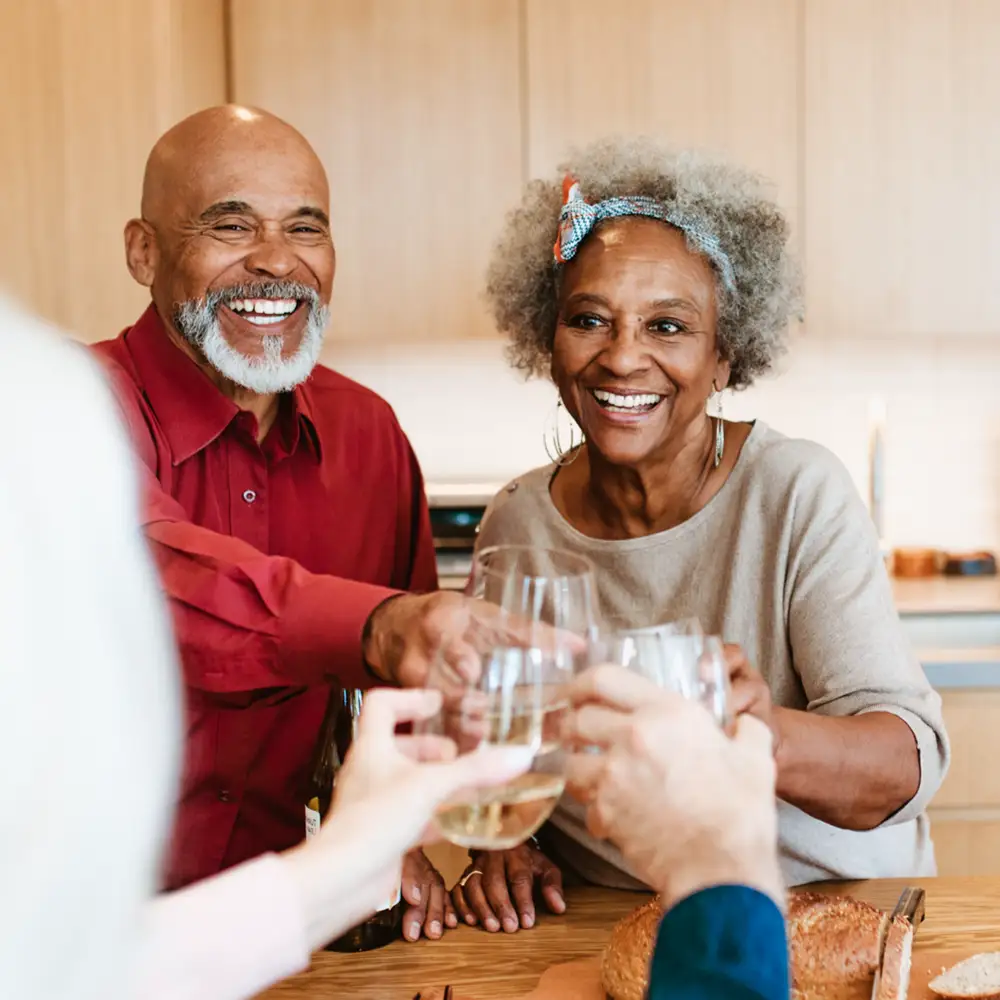 ABOUT Infectious Energy Senior couple smiling outdoors at night