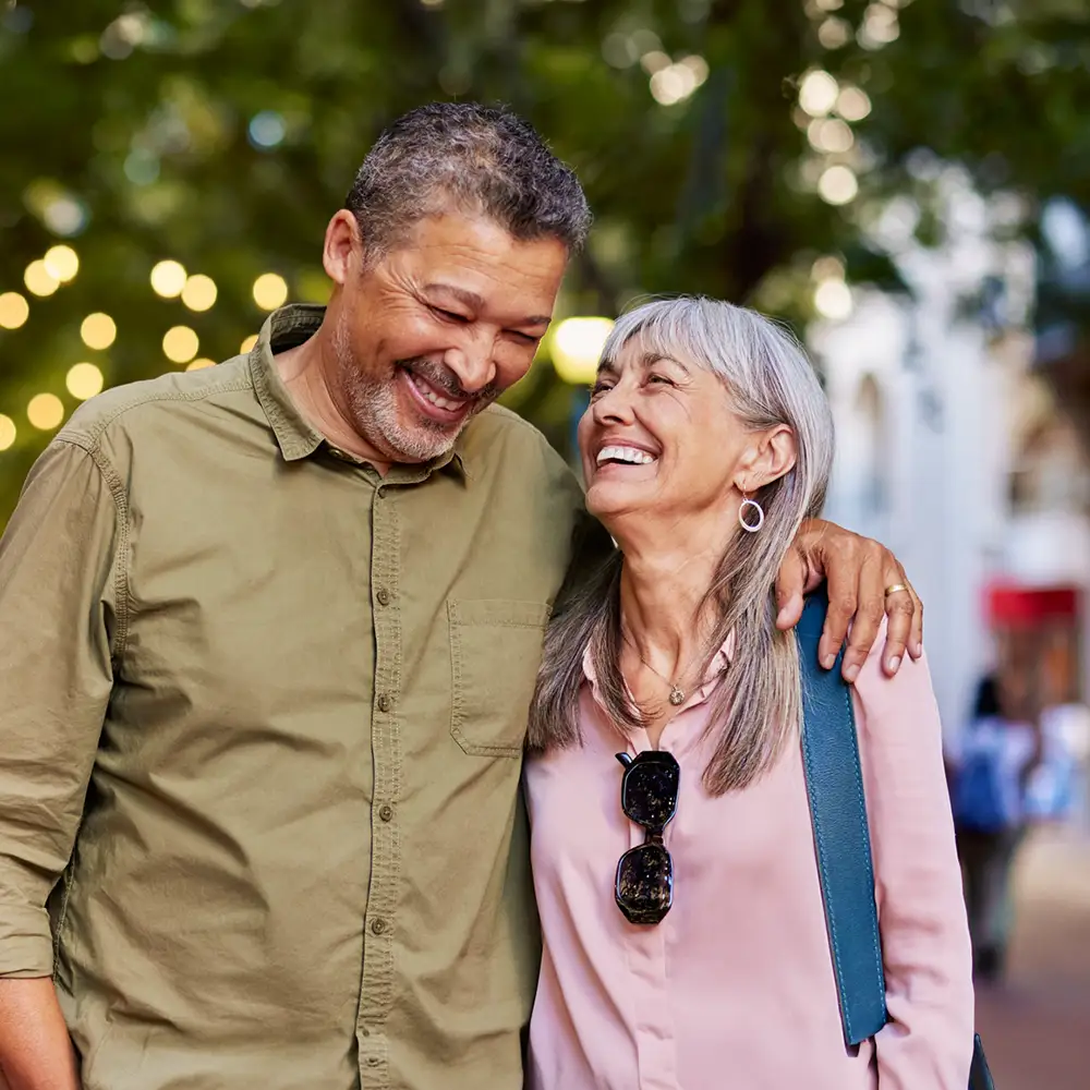 Senior couple smiling outdoors at night