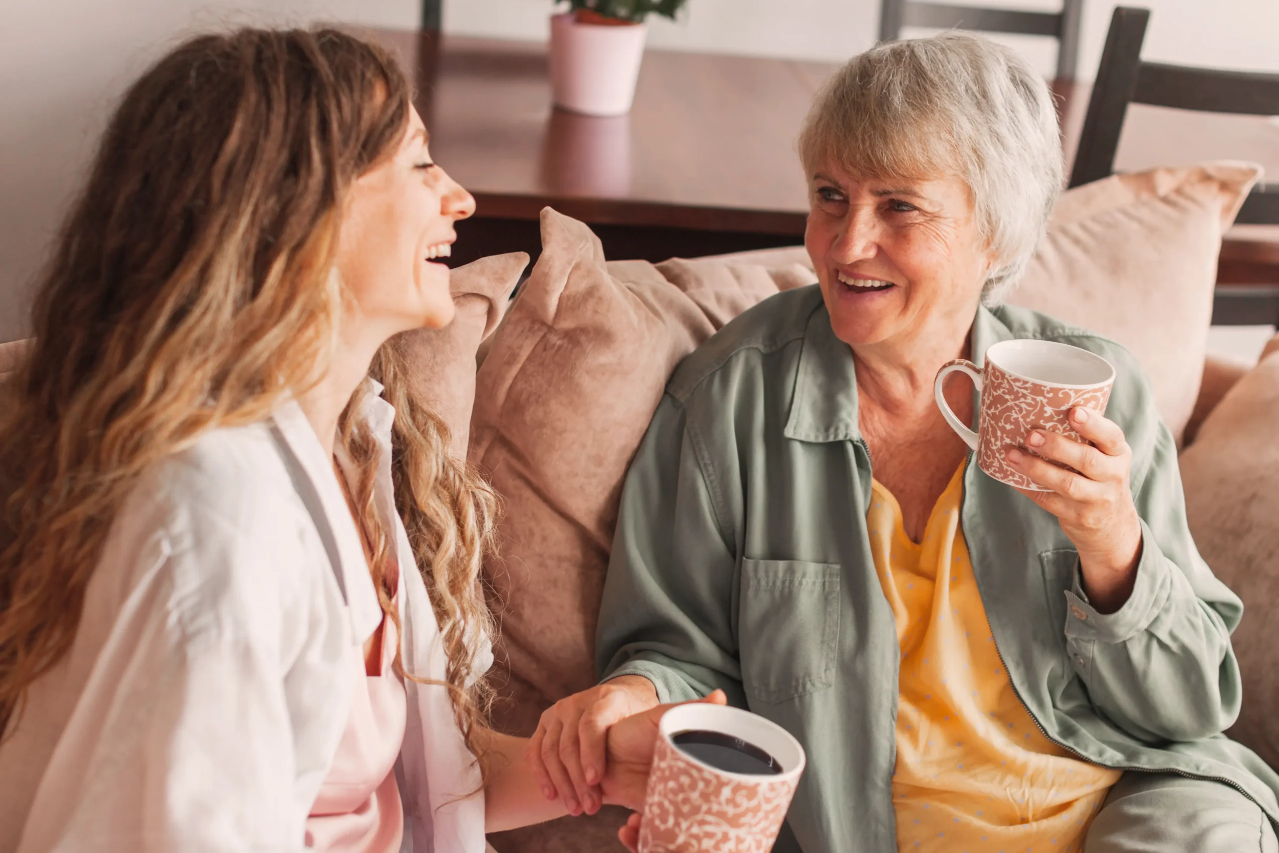 Senior woman with her adult daughter looking at a cell phone